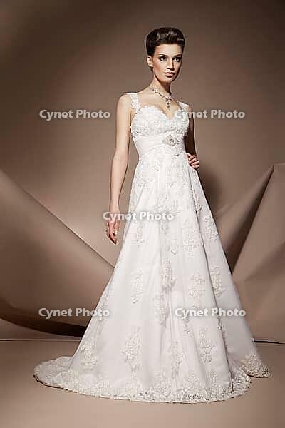 The beautiful young woman posing in a wedding dress [IBR123723170]