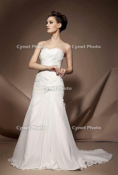 The beautiful young woman posing in a wedding dress [IBR123723177]