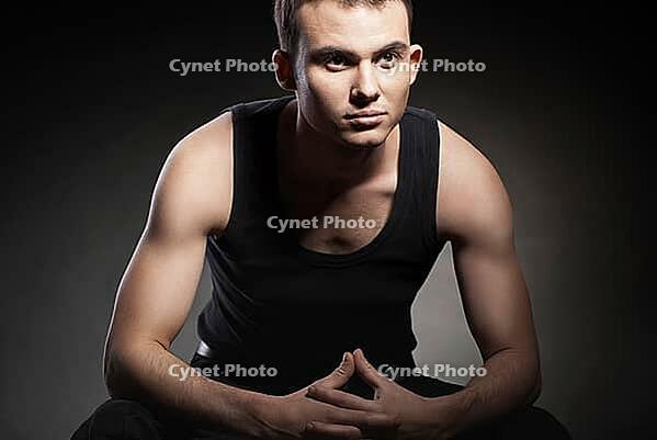 Closeup portrait of a sexy male model on dark grey background [IBR123723231]