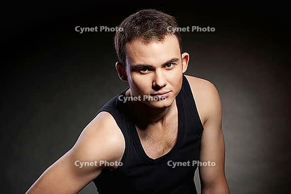 Closeup portrait of a sexy male model on dark grey background [IBR123723232]