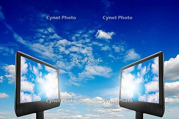 Two computer monitors with clouds on th screen, cloud computing concept [IBR123760801]