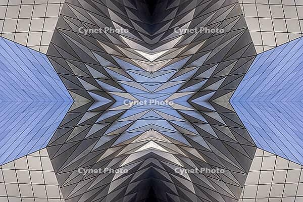 Abstract photography with a symmetrical, diamond-shaped shape that consists of repetitive lines and surfaces in shades of gray, white and blue and creates an impression of rhythm, depth and cool geometric harmony [IBR123760820]