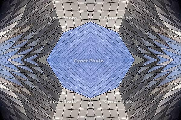 Abstract photography with a symmetrical, diamond-shaped shape that consists of repetitive lines and surfaces in shades of gray, white and blue and creates an impression of rhythm, depth and cool geometric harmony [IBR123760822]