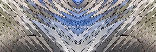 Abstract photography with a symmetrical, diamond-shaped shape that consists of repetitive lines and surfaces in shades of gray, white and blue and creates an impression of rhythm, depth and cool geometric harmony [IBR123760825]