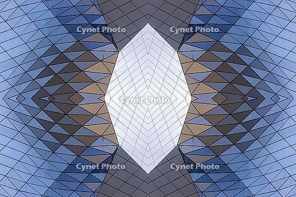 Abstract photography with a symmetrical, crystalline form, consisting of intertwined diamond-shaped surfaces in shades of blue, gray and subtle brown, which create a sense of depth, structure and cool architectural dynamism [IBR123760833]