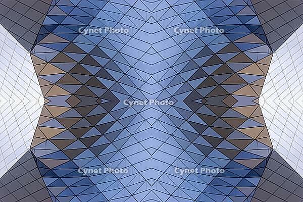 Abstract photography with a symmetrical, crystalline form, consisting of intertwined diamond-shaped surfaces in shades of blue, gray and subtle brown, which create a sense of depth, structure and cool architectural dynamism [IBR123760834]