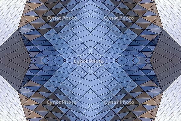 Abstract photography with a symmetrical, crystalline form, consisting of intertwined diamond-shaped surfaces in shades of blue, gray and subtle brown, which create a sense of depth, structure and cool architectural dynamism [IBR123760835]