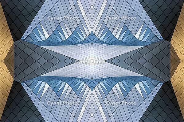 Abstract photography with symmetrical, sharp geometric forms of architecture in cool shades of gray and blue as well as warm beige, emphasizing the contrast of light, shadow and structure [IBR123760838]
