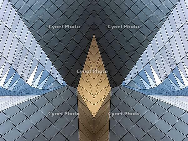 Abstract photography with symmetrical, sharp geometric forms of architecture in cool shades of gray and blue as well as warm beige, emphasizing the contrast of light, shadow and structure [IBR123760840]