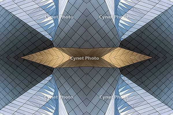 Abstract photography with symmetrical, sharp geometric forms of architecture in cool shades of gray and blue as well as warm beige, emphasizing the contrast of light, shadow and structure [IBR123760841]