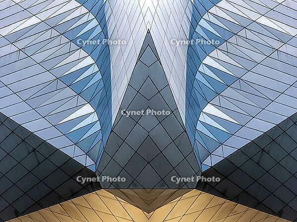 Abstract photography with symmetrical, sharp geometric forms of architecture in cool shades of gray and blue as well as warm beige, emphasizing the contrast of light, shadow and structure [IBR123760848]