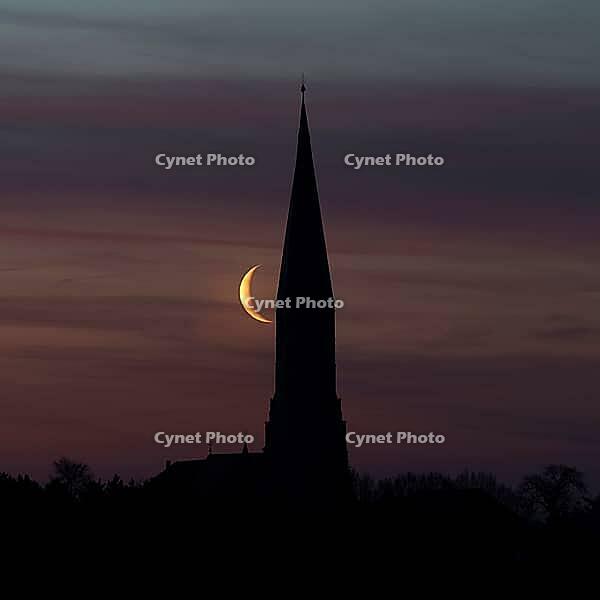 Crescent moon with waning moon next to the church tower of the pilgrimage church of St. Aegidius in Schildthurn, dawn, dawn, silhouette, Lower Bavaria, Bavaria, Germany [IBR123760856]