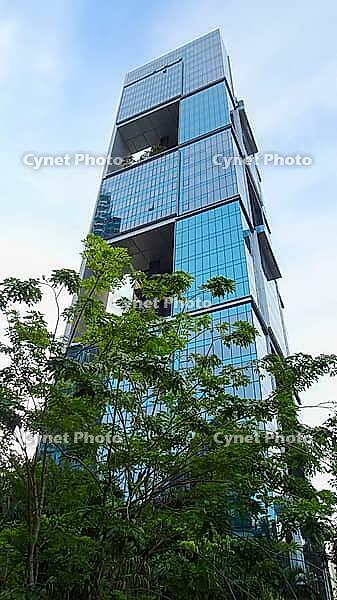 An impressive high-rise building with glass façade and distinctive architectural style rises into the sky, Singapore, Singapore [IBR123769654]