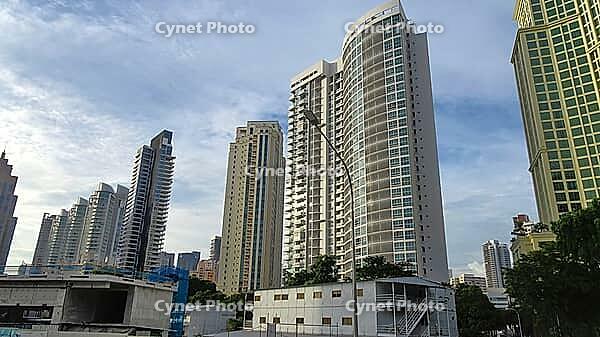 Modern skyscrapers rise into the sky of a city surrounded by trees and clear blue sky, Singapore, Singapore [IBR123769661]