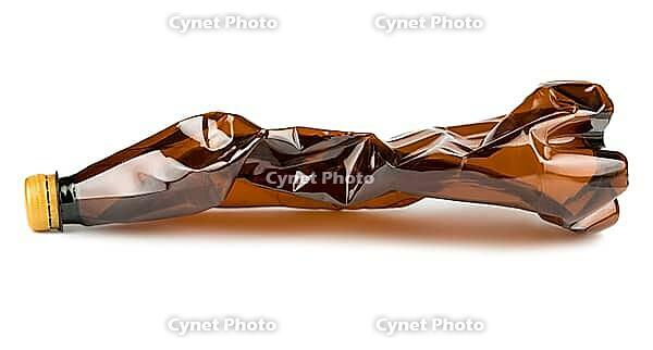 Crumpled brown plastic bottle isolated on white background [IBR123878865]