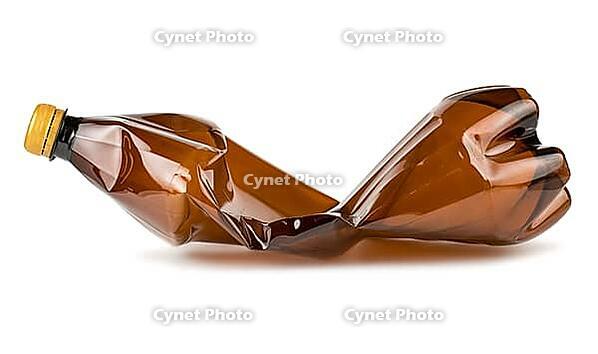 Crumpled brown plastic bottle isolated on white background [IBR123878866]