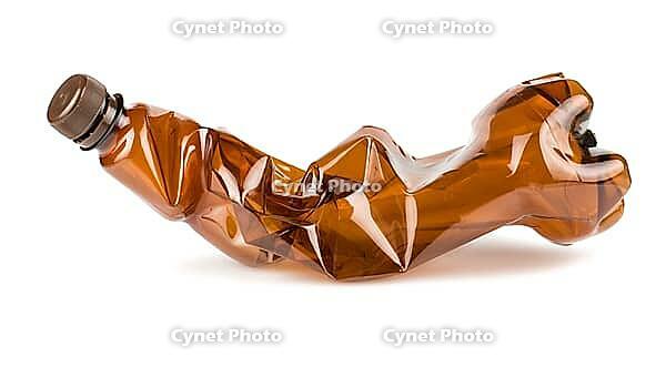 Crumpled brown plastic bottle isolated on white background [IBR123878867]