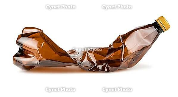 Crumpled brown plastic bottle isolated on white background [IBR123878868]