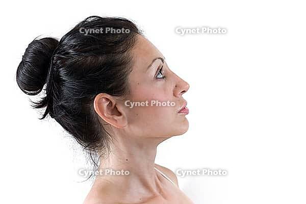 Close up of the face of a young woman with light skin and natural tones [IBR123878890]