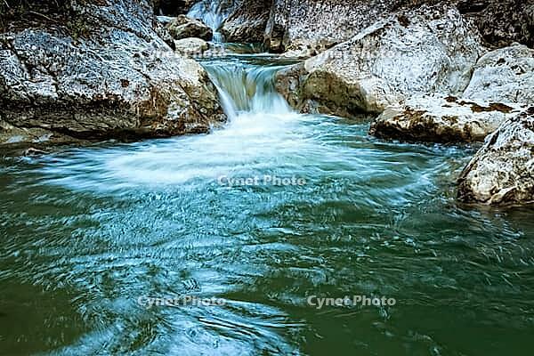 Raging clean fresh mountain river flowing between rocks [IBR123878895]