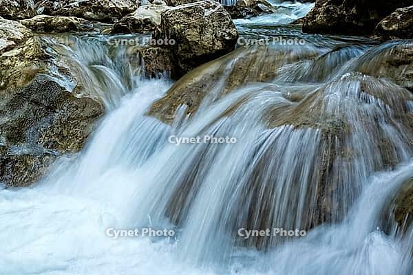 Raging clean fresh mountain river flowing between rocks [IBR123878896]