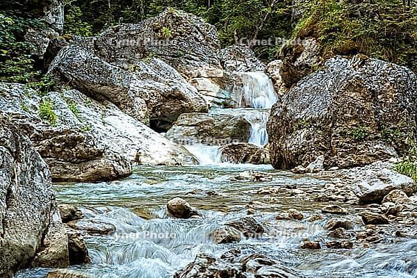 Raging clean fresh mountain river flowing between rocks [IBR123878902]