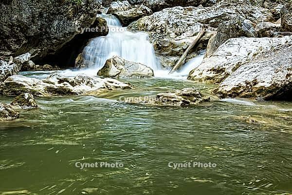 Raging clean fresh mountain river flowing between rocks [IBR123878904]