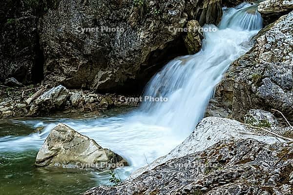 Raging clean fresh mountain river flowing between rocks [IBR123878905]