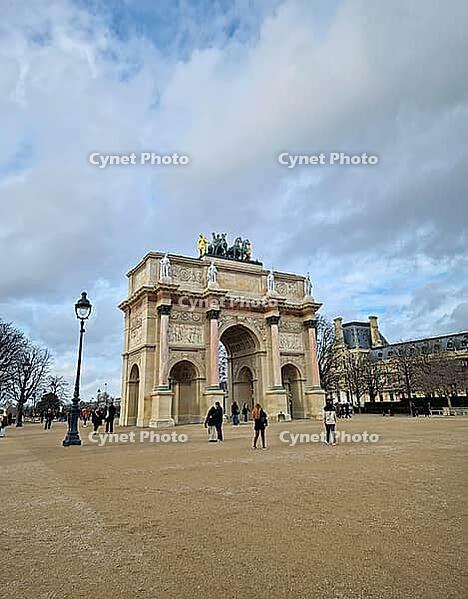 Paris, France - December 10, 2025: the Arc de Triomphe du Carrousel reveals the intricate marble columns of neoclassical architecture and golden Quadriga statue atop the monument [IBR123895588]