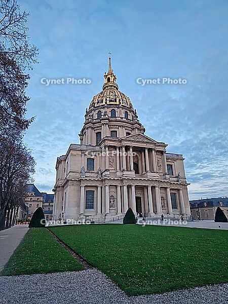 Stunning exterior view of the gilded Dome des Invalides in Paris, France. The cobblestone courtyard and the Saint-Louis Cathedral at dusk. Monumental Baroque architecture [IBR123895595]