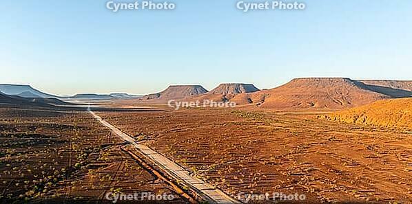 Aerial view, road leading through dry desert landscape, hills in Damaraland, Namibia [IBR123990967]