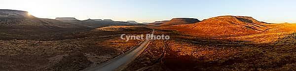 Aerial view, road leading through dry desert landscape, hills in Damaraland, Namibia [IBR123990974]