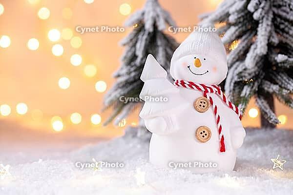 Snowman toy on the snow Christmas or New Year festive greeting card template [IBR123990987]