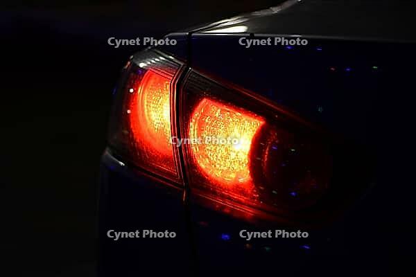 Discounted rear car lights in the dark. Stop signals [IBR123999808]