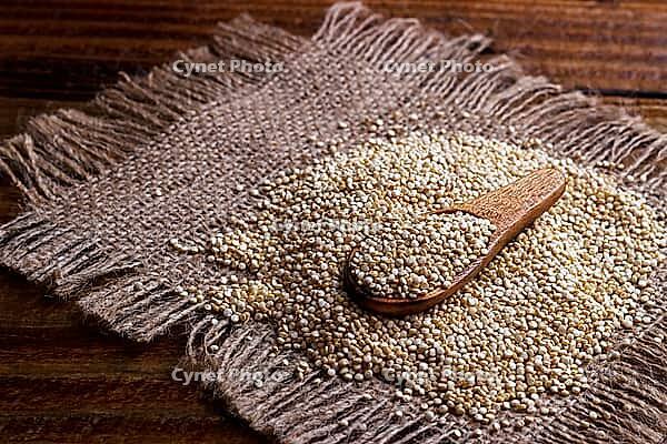 Heap of quinoa seeds, organic healthy vegan food on dark wooden background [IBR123999882]