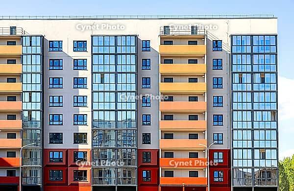 Facade fragment of new bright colorful modern residential building [IBR124036431]