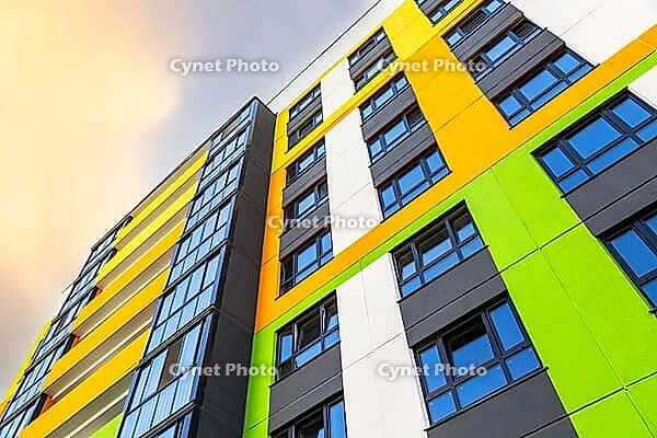 Facade fragment of new bright colorful modern residential building [IBR124036432]
