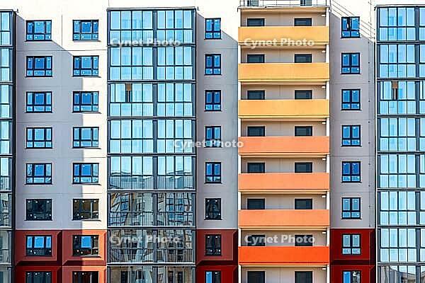 Facade fragment of new bright colorful modern residential building [IBR124036446]