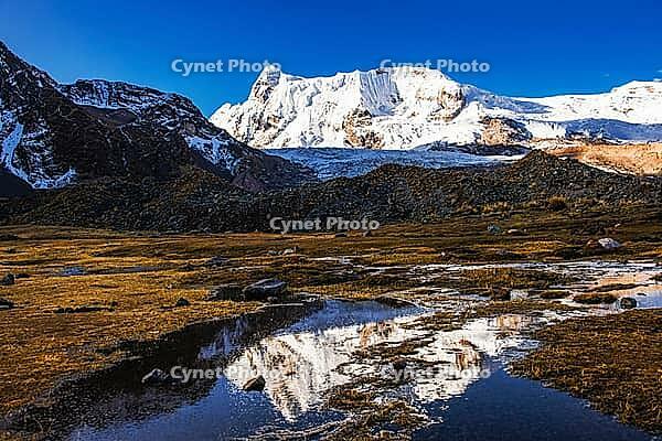 Summit of Ausangate (Spanish) or Awsangati (Quechua), reflected in a stream, 6384 m Ausangate Trek, Pitumarca, Cordillera Vilcanota, Peru [IBR124036487]