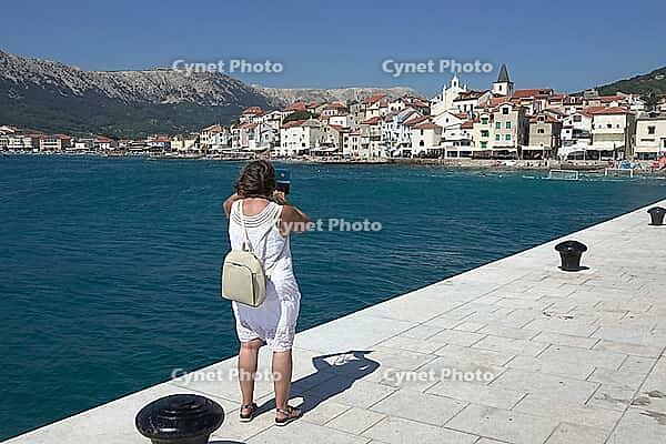 Woman on the coast of Basla on Krk, Croatia [IBR124051671]