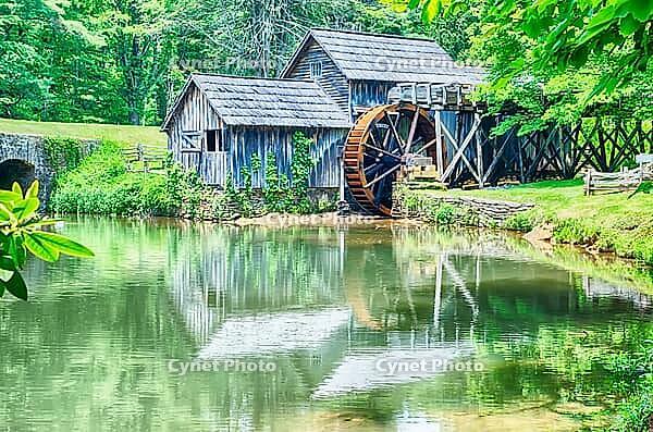Historic Edwin B. Mabry Grist Mill (Mabry Mill) in rural Virginia on Blue Ridge Parkway and reflection on pond in summer [IBR124083582]
