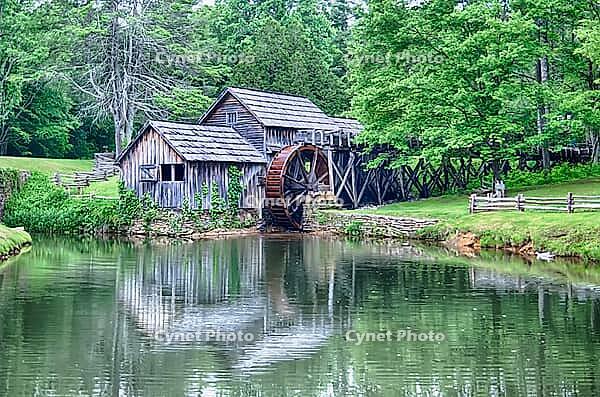 Historic Edwin B. Mabry Grist Mill (Mabry Mill) in rural Virginia on Blue Ridge Parkway and reflection on pond in summer [IBR124083616]