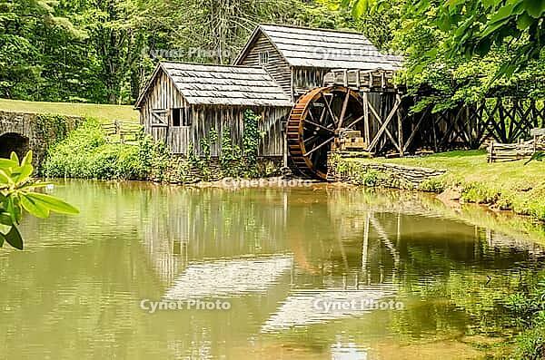 Historic Edwin B. Mabry Grist Mill (Mabry Mill) in rural Virginia on Blue Ridge Parkway and reflection on pond in summer [IBR124083642]