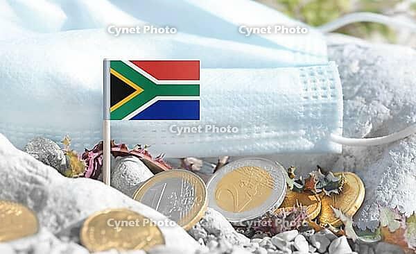 South Africa flag with euro currency coins and a medical mask on rocky ground.International healthcare costs, cross-border medical funding, Europe and South Africa cooperation and global health finance [IBR124084106]