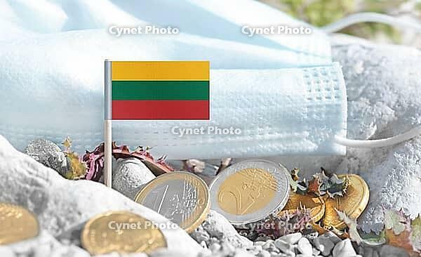 Lithuanian flag with euro currency coins and a medical mask on rocky ground.Eurozone healthcare costs, medical funding challenges and the financial weight of modern services connected to Lithuania [IBR124084109]