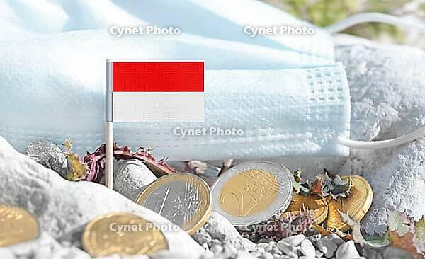 Indonesian flag with euro currency coins and a medical mask on rocky ground.International healthcare costs, cross-border medical funding, Indonesia and Europe cooperation and global health finance [IBR124084110]