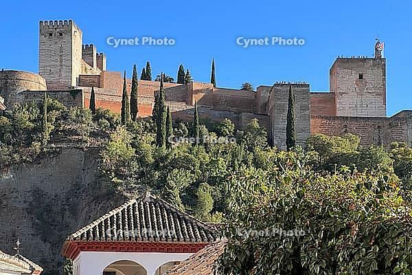 Alhambra fortress on hill with cypresses, Granada, Andalucia, Spain [IBR124084167]