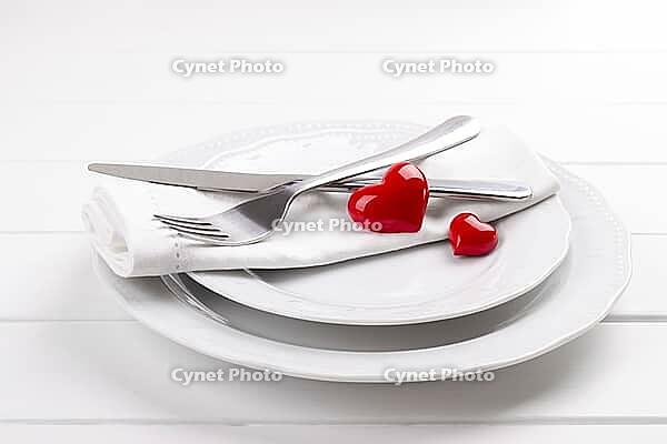 Romantic table setting on white wooden table.Valentine's day card template [IBR124084178]