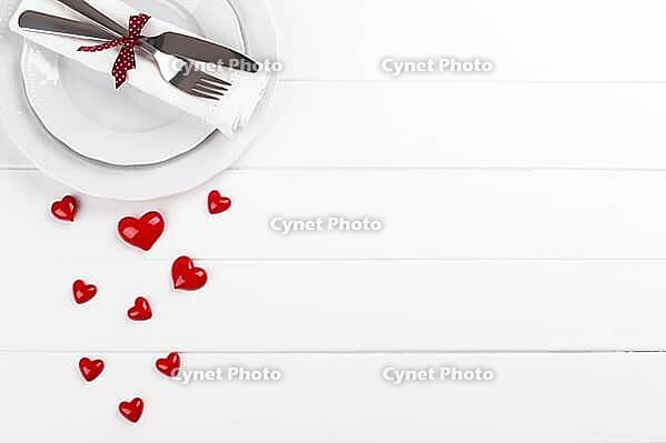 Romantic table setting on white wooden table Valentine's day card template [IBR124084180]