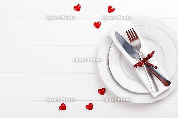 Romantic table setting on white wooden table.Valentine's day card template [IBR124084187]